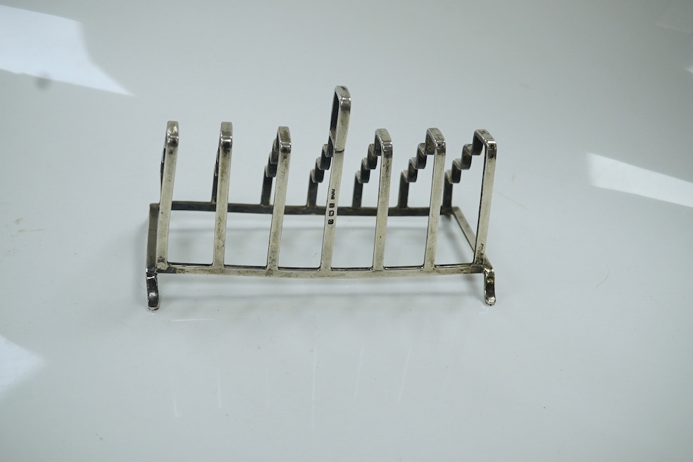 An unusual George V stepped silver seven bar toast rack, by A L Davenport Ltd, Birmingham, 1938, length 13.4cm. Condition - fair